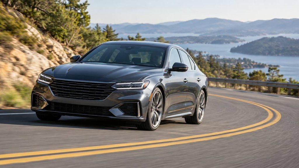 Modern sedan cornering on a winding road to illustrate suspension control and body movement